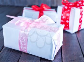 boxes for present  with ribbon on a table
