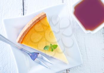 sweet cheesecake on plate and tea in cup