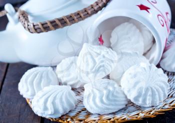 meringues in bowl and on a table