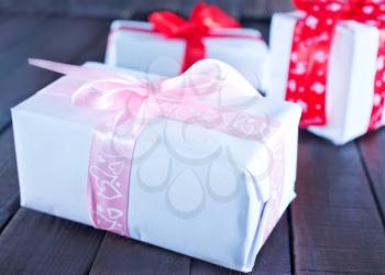 boxes for present  with ribbon on a table