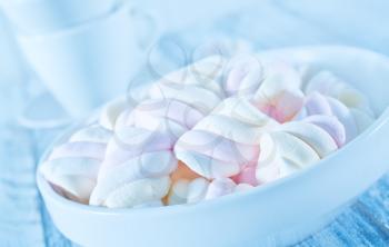 marshmallows in bowl and on a table