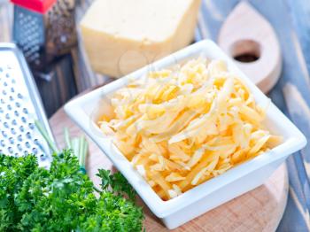 grated cheese in bowl and on a table