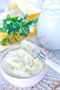 mashed potato in bowl and on a table