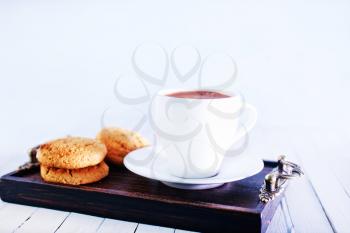 cookies and tea in cup and on a table