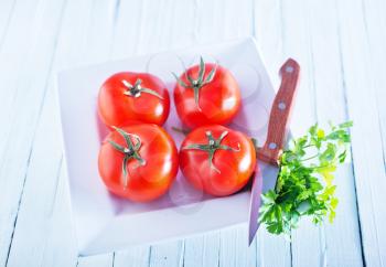 raw tomato on the white table, fresh tomato