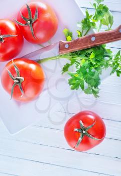 raw tomato on the white table, fresh tomato