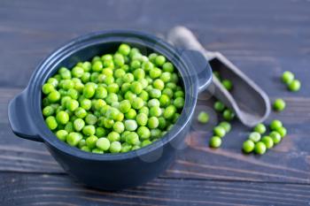 green pea in the bowl and on a table
