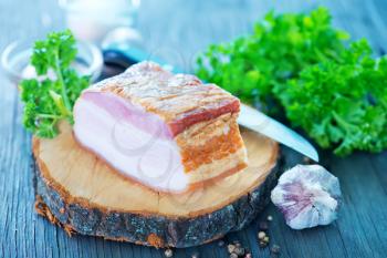 smoked lard with spice on the wooden board