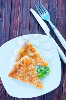 cheese pizza on plate and on a table