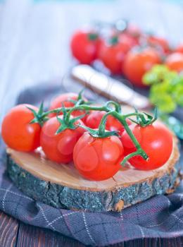 fresh tomato on wooden board and on a table