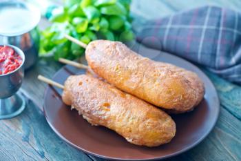 corndogs on plate and on a table