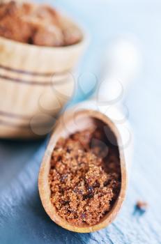 brown sugar in wooden spoon and on a table