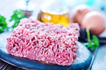 raw minced meat on the wooden board
