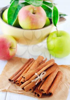 cinnamon and apples on the wooden table