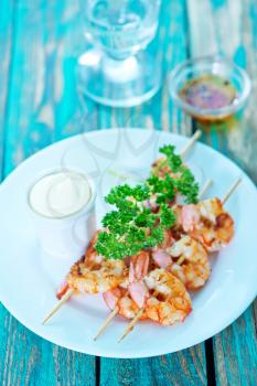 fried shrimps on white plate and on a table