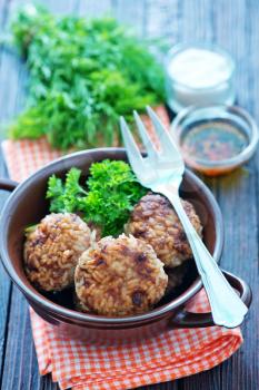 cutlets in bowl and on a table