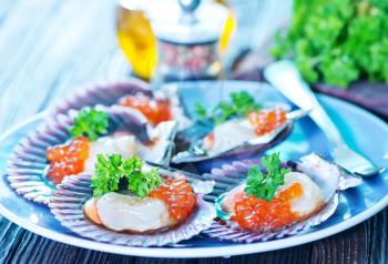 scallop on plate and on a table