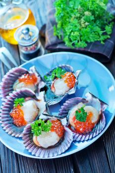 scallop on plate and on a table