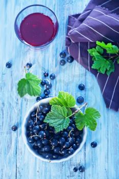 fresh black currant in bowl and on a table