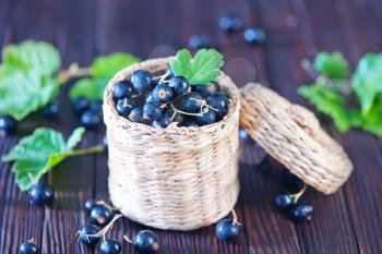 black currant in basket and on a table
