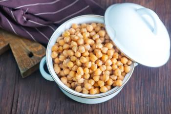 chickpeas in metal bowl and on a table