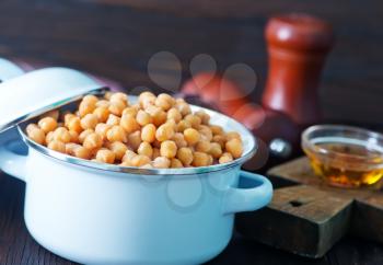 chickpeas in metal bowl and on a table