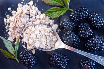 oat flakes and fresh blackberry on a table