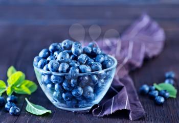 blueberry in bowl and on a table