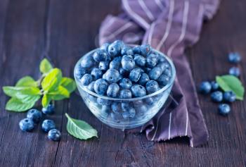 blueberry in bowl and on a table