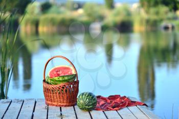 fresh watermelon on the wooden pier, pier on lake