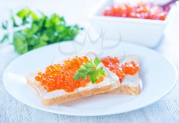 salmon caviar and bread on a table