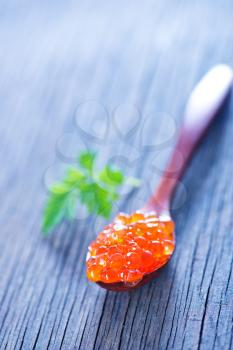 red salmon caviar with fresh parsley on a table