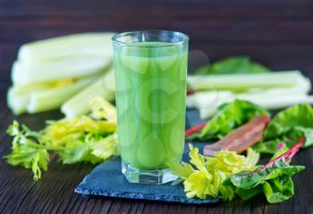fresh vegetable juice in glass and on a table