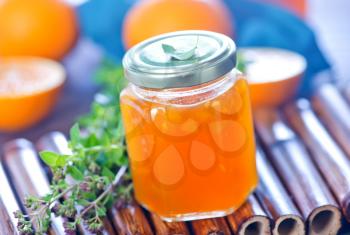 orange jam in glass bank and on a table