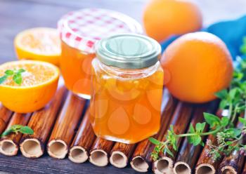 orange jam in glass bank and on a table