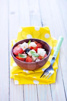 greek salad in bowl and on a table