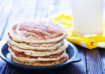 sweet pancakes on plate and on a table