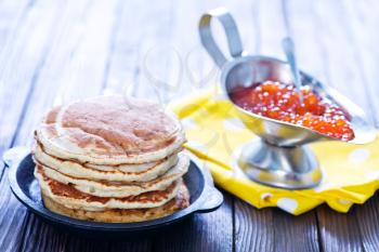 pancakes with red salmon caviar on plate