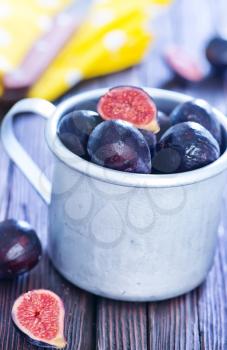 fresh figs in metal cup and on a table