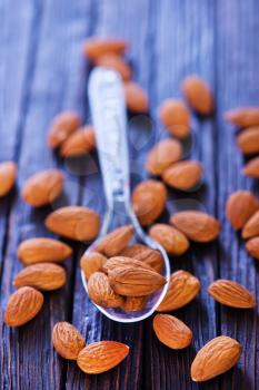 dry almond in spoon and on a table