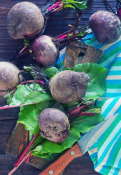 raw beet and knife on the wooden table