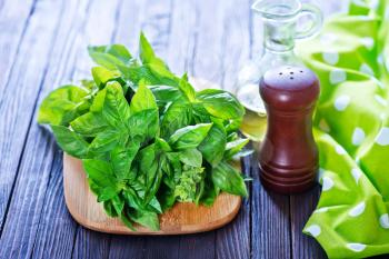 fresh basil on board and on a table