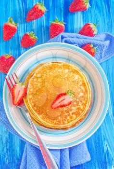 pancakes on plate and fresh strawberries