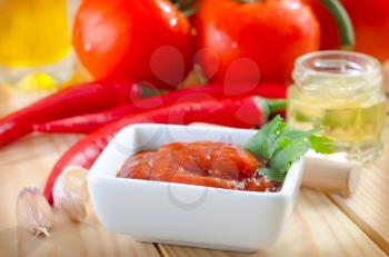 tomato and chilli  sauce in the white bowl