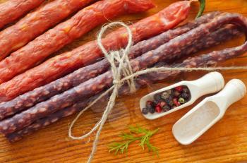 sausages on the wooden table with aroma spice