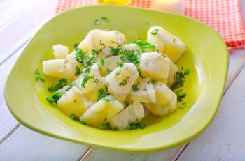 boiled potato with greens in the green plate