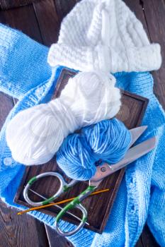 knitting on a table, blue threads for knitting