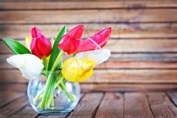 tulips in vase and on a table