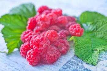 fresh raspberry and green leaves on the white table
