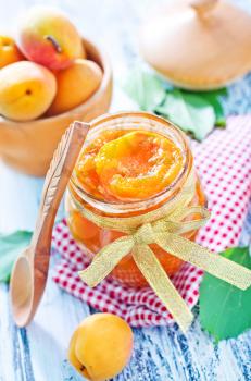 apricot jam in glass bank and on a table